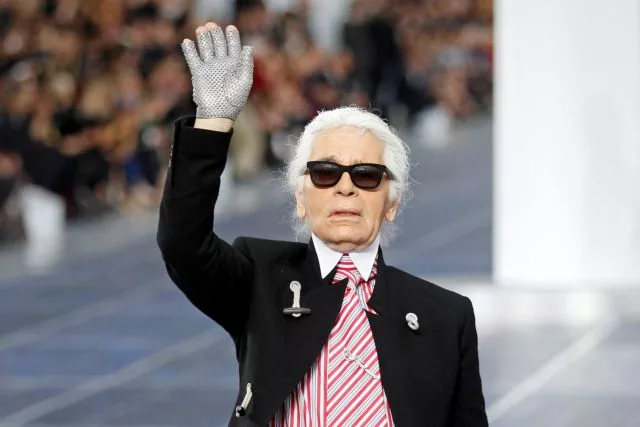 FILE PHOTO German designer Karl Lagerfeld appears at the end of his Spring/Summer 2013 women's ready to wear fashion show for French fashion house Chanel during Paris fashion week